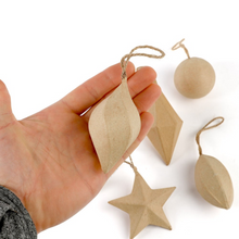 Load image into Gallery viewer, A hand holds a small leaf-shaped wooden ornament with a twine loop, while four more matching wooden ornaments in star, diamond, and round shapes are arranged on a white background.