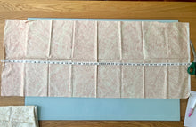 Load image into Gallery viewer, Paris Flea Market Pink Fabric by 3 Sisters Moda laid out with tape measure