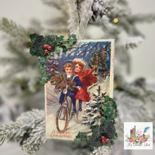 Load image into Gallery viewer, A Merry Christmas Victorian Postcard Ornament, Holiday Bike Ride