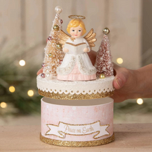 Load image into Gallery viewer, Decorative angel figurine with Christmas trees on a box, featuring 'Peace on Earth' text.