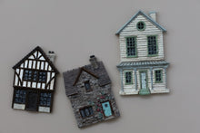 Load image into Gallery viewer, Three miniature decorative house figurines in different architectural styles displayed on a plain beige background.