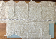 Load image into Gallery viewer, View of Paris Flea Market Fabric by 3 Sisters Moda with cut edges and tape measure laid across 