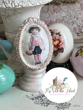 Load image into Gallery viewer, Decorated egg decoupaged with Easter Minis Rice Paper with a small Victorian girl figure, trimmed in Frames Mould Clay castings painted pink.