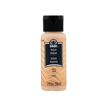 Load image into Gallery viewer, A bottle of FolkArt Texture Medium paint in the color Earth Sand, featuring a black cap and a textured beige label on a white background.