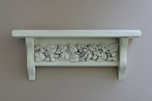 Load image into Gallery viewer, A white-painted wooden shelf with a decorative relief band of carved leaves and acorns, mounted on a plain taupe wall.