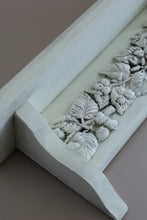 Load image into Gallery viewer, Close-up of a white decorative molding or shelf trim with a carved leaf and grape motif, shown against a muted taupe background.