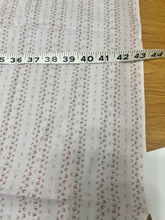 Load image into Gallery viewer, Closeup view of Yuwa Live Life Collection Pink Ditsy Rose Fabric with tape measure
