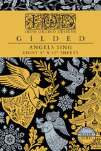 Load image into Gallery viewer, Cover of the Iron Orchid Designs 'Gilded' sheet set, featuring a gold and black background with silver-gray illustrations of angels, a Christmas tree, and snowflakes. Text indicates eight 8" x 12" sheets.