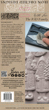 Load image into Gallery viewer, Back cover of the Iron Orchid Designs 'With Love, The Iod Family' Jod Moulds book, featuring product information, a barcode, and a photo of a hand holding a carved stone mold.