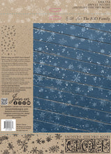 Load image into Gallery viewer, Back cover of an Iron Orchid Designs 'With Fox The IOD Family' decorative stamp book, featuring a blue wood-grain panel with white snowflakes on the right and product details, barcode, and branding on the left.