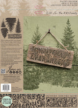 Load image into Gallery viewer, Back packaging of a 'Christmas Evergreen' iron-on design from Iron Orchid Designs, featuring a rustic wooden hanging sign with the words 'CHRISTMAS EVERGREEN' over a green pine forest background, alongside product details and application examples.