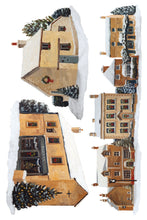 Load image into Gallery viewer, A watercolor-style illustration of several small houses in a snowy village, arranged on a white background. The scene includes warm beige and brown buildings with snow-covered roofs, dark chimneys, windows, and evergreen trees with ornaments.