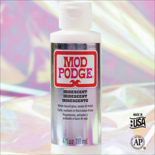 Load image into Gallery viewer, A bottle of Mod Podge Iridescent water-based glue, sealer &amp; finish, shown against a colorful iridescent background. The bottle is white with a silver label featuring the red and white Mod Podge logo.