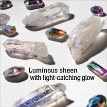 Load image into Gallery viewer, Several clear and iridescent crystal points and faceted gemstones arranged on a white background with bold text reading 'Luminous sheen with light-catching glow.' This is a styled product shot rather than a person-in-environment scene, so subject_type is Product/Packaging.