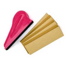 Load image into Gallery viewer, A bright pink plastic car window cleaner brush with black bristles, shown next to five beige microfiber cleaning towels on a plain white background.