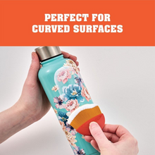 Load image into Gallery viewer, Demonstrating use of Mod Podge Small Decoupage Brush on a floral-patterned water bottle with curved surface feature with an orange and white background.