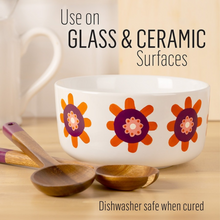 Load image into Gallery viewer, Ceramic bowl with floral design on a wooden surface with wooden spoons, text indicating use on glass and ceramic surfaces.
