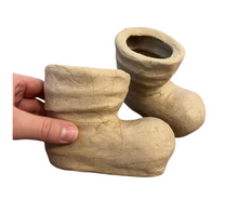 Load image into Gallery viewer, Handmade clay boot-shaped planters held by a hand on a white background