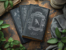 Load image into Gallery viewer, Decorative black books or journals decorated with IOD Gilded silver Transfer designs on a rustic wooden surface with green leaves