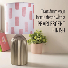 Load image into Gallery viewer, Lamp with a pearlescent finish shade on a table with a plant and books in the background.