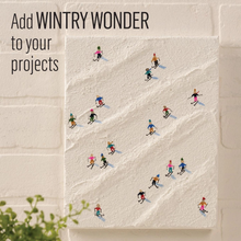Load image into Gallery viewer, Illustration of skiers on a snowy slope with text 'Add WINTRY WONDER to your projects'.